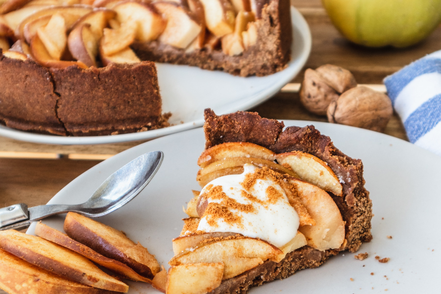 Quittentarte: Ein Stück Quittenkuchen im Vordergrund mit einem angeschnittenen Kuchen im Hintergrund